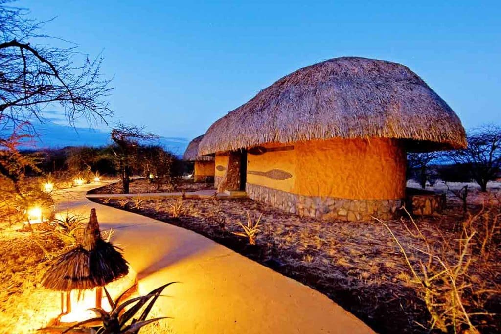 A safari lodge, thatched roofs and dusk in Amboseli